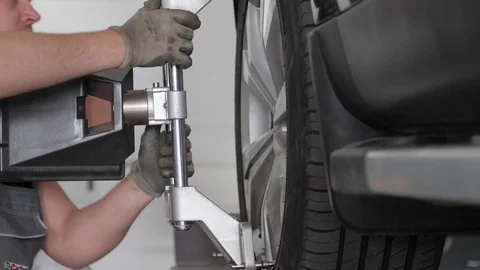 Wheel alignment for vehicle in сar workshop, fix machine wheels, Stock Footage 76889066