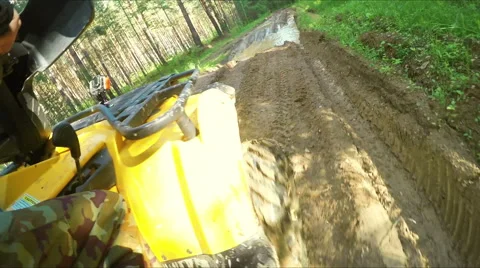 Wheel ATV drives into a deep mud puddle Stock Footage 57707625