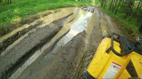 Wheel ATV drives into a deep mud puddle Stock Footage 57707771