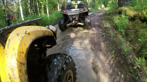 Wheel ATV drives into a deep mud puddle Stock Footage 57708141