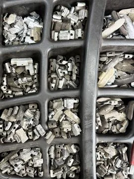 Wheel balancing weights in auto workshop tray Stock Photos