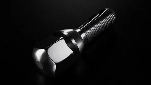 Wheel Bolt Close up Rotation in Seamless Loop Showcasing Dark Metallic Finish Stock Footage 319686302