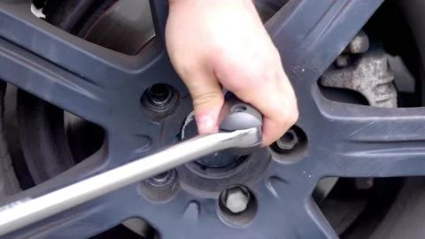 Wheel bolt / nut being loosened during car repairs Stock Footage 157060946