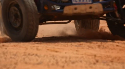 Wheel of the buggy running past in the clouds of sand Stock Footage 49409507
