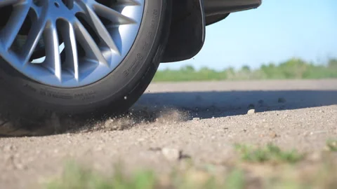 Wheel of car are slip on a dirt road during start of movement. Slow motion Stock Footage