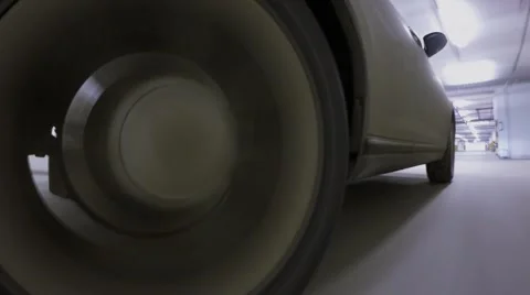 Wheel of car which drives by underground parking. Timelapse Stock Footage 67649115