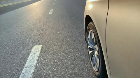 The wheel of the car while driving on an asphalt road. Stock Footage 244418468