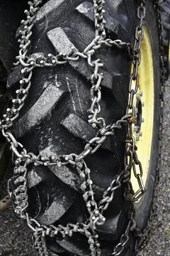 Wheel chains on the wheel of the tractor Stock Photos