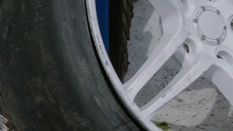 Wheel close up. The rubber on a rim is worn down to a metal cord Stock Footage 129510405