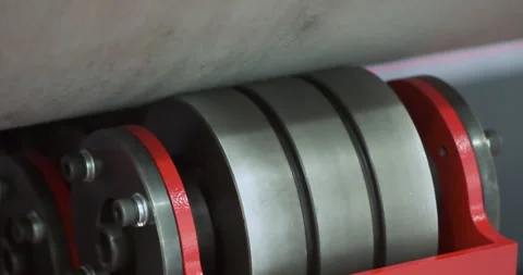 A wheel drive rotates a large round part, like part of a large industrial mac Stock Footage 325611928