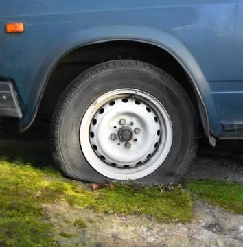 Wheel with a flat tire Stock Photos