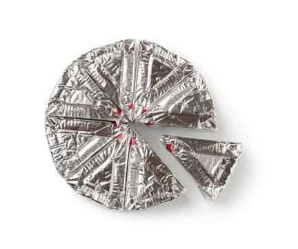 Wheel of foil wrapped processed cream cheese slices isolated on a white. Stock Photos