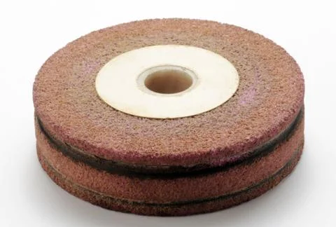 Wheel of a grinder on the white background Stock Photos