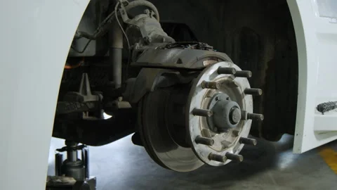 Wheel hub on the track, Various devices and semi truck in a repair shop Stock Footage 297022867