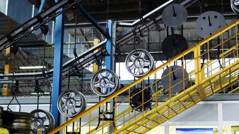 Wheel hubcaps moving on an assembly line inside a factory 4K Stock Footage 138258328