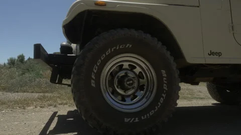 Wheel of a Jeep moving through the sand Stock Footage 200859428