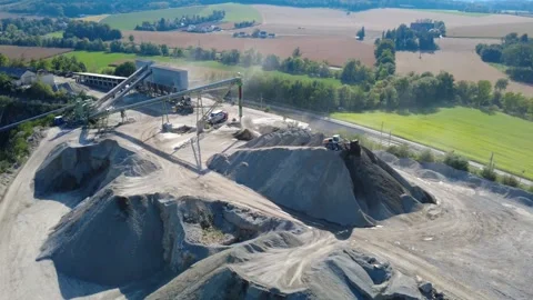 Wheel Loader Dumping Crushed Stone at Granite Quarry – Aerial Orbit Stock-Footage 347948611