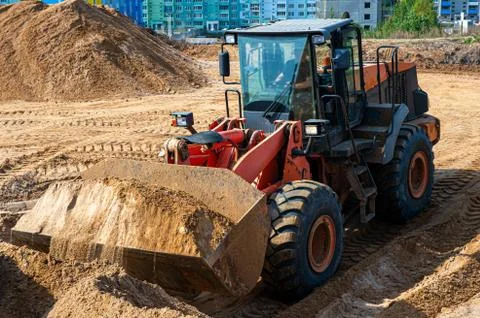 Wheel Loader At Eathmoving Works. Heavy construction machine. Wheel loader Stock Photos
