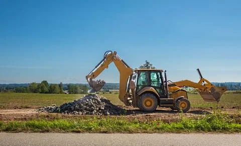 Wheel loader excavator with field background during earthmoving work, const.. Stock Photos