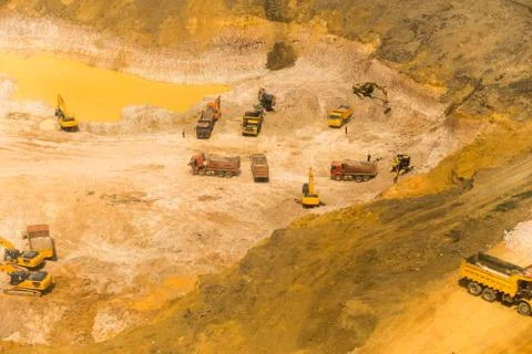 Wheel loader excavator unloading sand, tractors and dump truck inside constru Stock Photos
