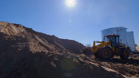 Wheel loader, with its large bucket in front, moves large amounts of land  Stock Footage 161955100
