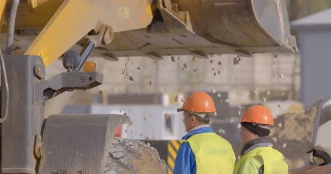 Wheel loader, with its large bucket in front, moves large amounts of gravel  Stock Footage 161958882