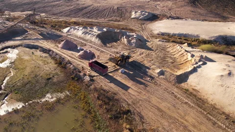 Wheel loader load the sand into dump truck in open pit. Stock Footage 167415106