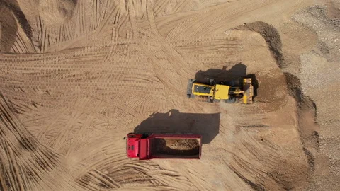 Wheel loader load sand in dump truck in open pit. Heavy machinery in opencast Stock Footage 191644909