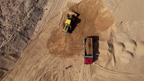 Wheel loader load sand in dump truck in open pit. Heavy machinery in opencast Видео 191645552