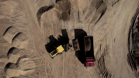 Wheel loader load sand in dump truck in open pit. Heavy machinery in opencast Stock Footage 191834403