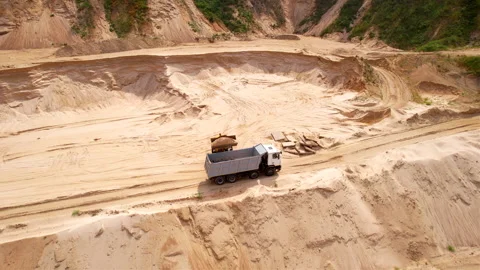 Wheel loader load sand in dump truck in open pit. Stock Footage 219865590