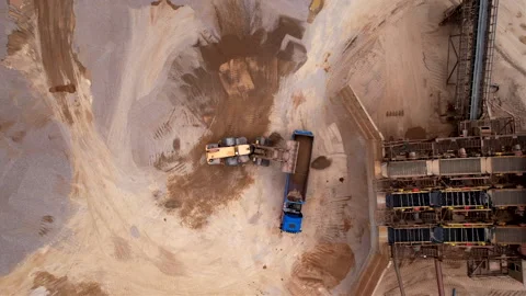 Wheel loader load sand in tipper truck in open pit. Loader on earthworks Stock Footage 193990749