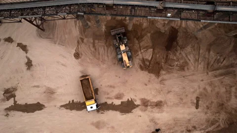 Wheel loader load sand in tipper truck in open pit. Loader on earthworks Stock-Footage 193993895