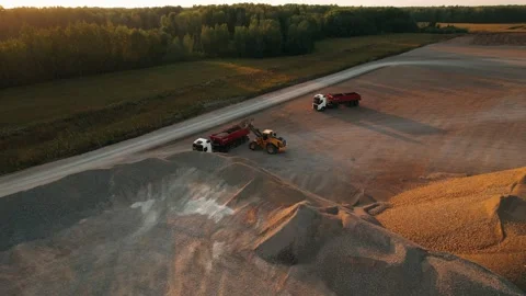Wheel loader loading crushed stone it to the dump truck. Mining work in open pit Video stock 237499203