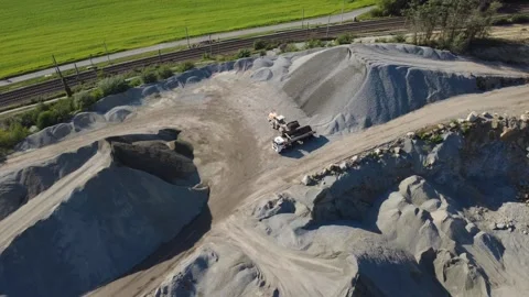 Wheel Loader Loading Crushed Stone into Truck at Granite Quarry Stock-Footage 347949629