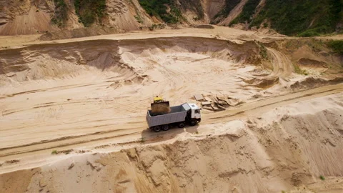 Wheel loader loading sand into dump truck in open pit mine. Stock Footage 161415149