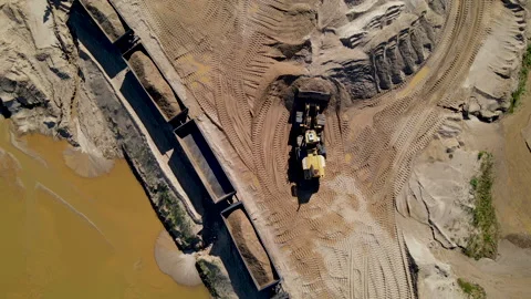 Wheel loader loading sand it to the freight train. Mining work in open pit. Stock Footage 156615905