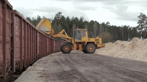 Wheel loader loads sawdust in the train Stock Footage 74820466