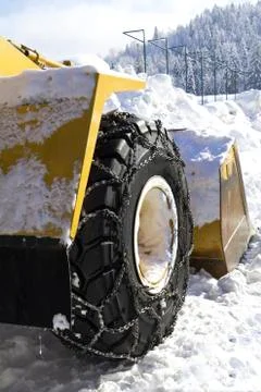 Wheel loader machine removing snow in winter on the road Stock Photos