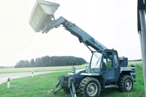 Wheel loader machine unloading rocks in the open-mine of iron ore Stock Photos