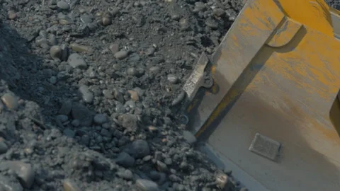 Wheel loader Mining equipment collects lots of rocks from the quarry ground Stock Footage 282790849