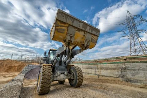 Wheel loader rides on a construction site. Stock Photos