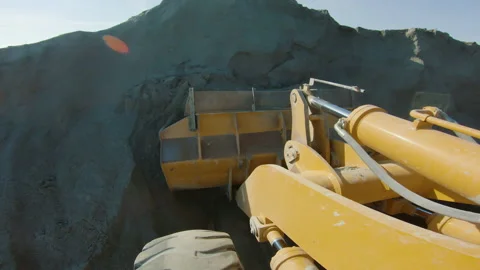 Wheel loader scoops crushed stone into bucket, heavy machinery working on quarry Video stock 164916713