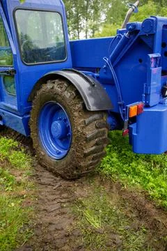 A wheel loader of the technical relief organization drives over the softened Stock Photos
