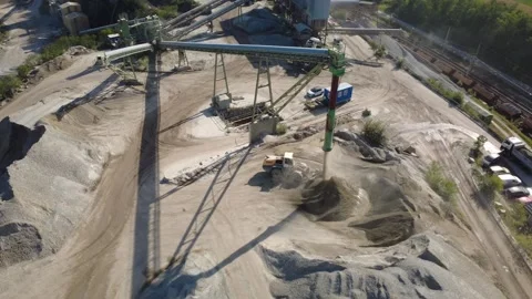 Wheel Loader Working Beneath Aggregate Conveyor at Granite Quarry Stock-Footage 347946919