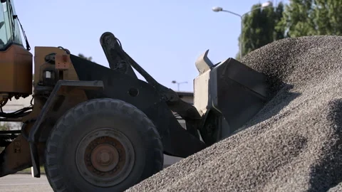 Wheel Loader's Bucket Loading A Scoop Of Gravel In A Tarmac Factory Stock Footage 142002731