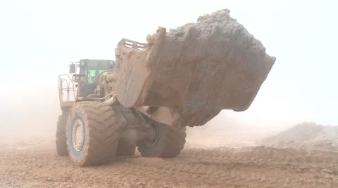Wheel-mounted loader comes out of the mist Stock Footage 52816994