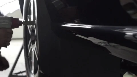 Wheel mounting on black car Stock Footage 72242442