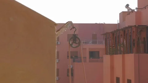 Wheel of pulley in a construction site pulling a thick rope in pink and pastel 스톡 동영상 110771448