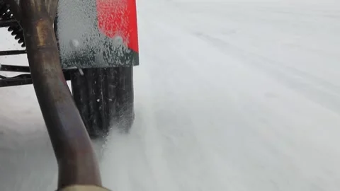 Wheel of racing car which drives by snow track at Video stock 299664817